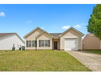 Charming single-story home featuring a well-maintained lawn and attached one car garage at 2659 Captains Watch Ne Rd, Kannapolis, NC 28083