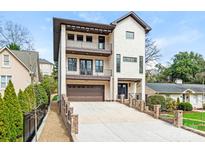 Stunning three-story home with a brick facade and multiple balconies at 2909 Hanson Dr, Charlotte, NC 28207
