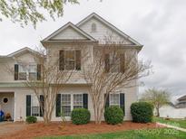 Charming two-story home with manicured lawn and updated siding details at 4130 Town Center Rd, Harrisburg, NC 28075