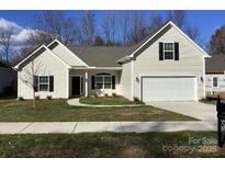 Charming single-Gathering home with a two-car garage and well-manicured lawn at 5126 Rocky River Crossing Rd, Harrisburg, NC 28075