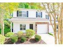 Charming two-story townhome featuring a stone veneer and a well-maintained front yard with mature trees at 162 Limerick Rd # C, Mooresville, NC 28115