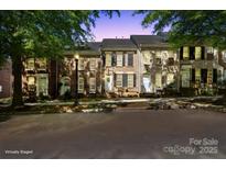 Charming brick townhomes featuring well-maintained landscaping and classic architectural details at twilight at 164 Singleton Rd, Mooresville, NC 28117