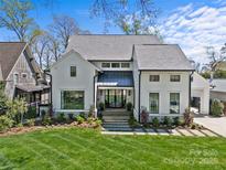 Stunning two-story home with manicured lawn, stone walkway, and modern curb appeal at 2637 Normandy Rd, Charlotte, NC 28209