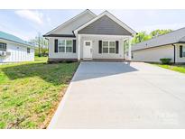 Charming single-story home with a concrete driveway and a covered front porch at 423 Pleasant Ave, Kannapolis, NC 28081