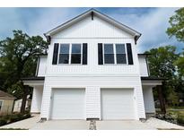 Charming two-story home with two-car garage, black shutters, and white siding at 615 Billingsley Rd, Charlotte, NC 28211