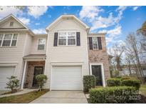 Charming townhome with a garage and well-maintained landscaping in a desirable neighborhood at 7445 Abigail Glen Dr, Charlotte, NC 28212