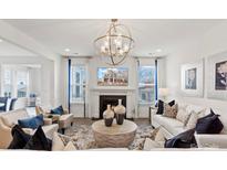 Bright living room with fireplace, modern light fixture, and neutral decor at 2212 Indigo Branch Rd, Indian Land, SC 29707