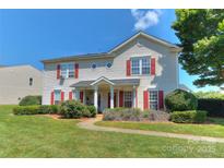 Charming two-story home featuring eye-catching red shutters and lush green landscaping at 3835 Mohawk Ct, Charlotte, NC 28215