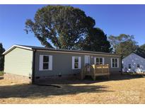 Charming single-story home with a covered entryway and a manicured lawn at 3925 Taylorsville Hwy, Statesville, NC 28625
