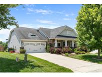 Charming home featuring a well-manicured lawn, a two-car garage, and a welcoming front porch at 4006 Fall Oak Ter, Fort Mill, SC 29707