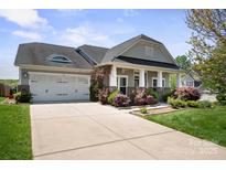 Charming single-story home with a two-car garage, inviting front porch, and well-maintained landscaping at 4006 Fall Oak Ter, Fort Mill, SC 29707