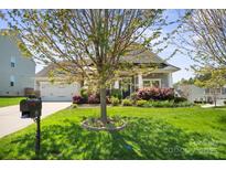 Charming single-story home with a well-manicured lawn, landscaping, and a two-car garage at 4006 Fall Oak Ter, Fort Mill, SC 29707