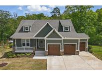 Inviting craftsman home with a three-car garage and manicured landscaping for stunning curb appeal at 4120 Spring Cove Way, Belmont, NC 28012