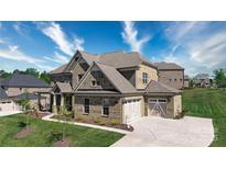 Beautiful brick home featuring a two-car garage and a well-manicured lawn on a sunny day at 8313 Balcony Bridge Rd, Huntersville, NC 28078