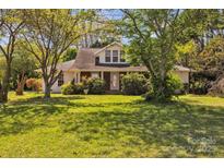 Charming home with mature landscaping, a well-manicured lawn, and an inviting front facade at 8974, 8972 & 8970 Nc 90 E Hwy, Stony Point, NC 28678