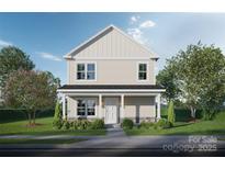 Charming two-story home with a covered front porch and well-manicured lawn and a mix of stone and vinyl siding at Lot 1 Tyler St, Kannapolis, NC 28083