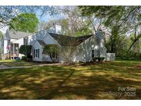 Charming home exterior featuring manicured lawn and mature trees providing ample shade at 1532 Hunt Club Ct, Rock Hill, SC 29732