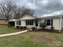Charming single-story home featuring a welcoming front porch and mature landscaping at 1628 B Se Ave, Hickory, NC 28602