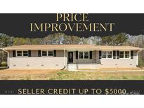 Charming single-story home with a brick facade, black shutters, and front lawn at 174 Maske Rd, Mount Gilead, NC 27306