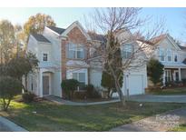 Inviting two-story home featuring stone accents, a manicured lawn, and an attached garage at 2125 Arbor Vista Dr, Charlotte, NC 28262