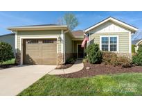 Charming home featuring a one car garage, stone accents, and an inviting covered porch at 314 Flat Rock Dr, Denver, NC 28037