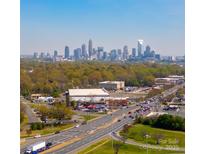 Sweeping aerial view of the city skyline with lush greenery and busy streets, offering a glimpse of urban living at 4429 Major St, Charlotte, NC 28208