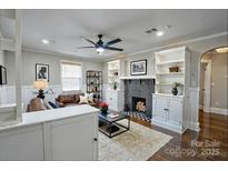 Inviting living room featuring a fireplace, built-in shelves, and a cozy seating area at 4429 Major St, Charlotte, NC 28208