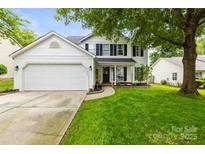 Charming two-story home with a well-manicured lawn and a two-car garage at 5549 Lemley Nw Rd, Concord, NC 28027