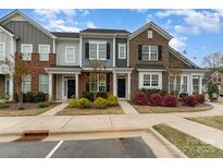 Charming townhome showcasing brick accents, colorful landscaping, and a welcoming entrance at 609 Sweet Bonnie Ln, Belmont, NC 28012
