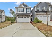 Charming two-story home featuring a stone facade, attached two-car garage, and a well-manicured lawn at 6563 Kinder Ln, Lancaster, SC 29720
