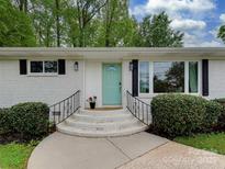 Charming exterior with a freshly painted brick and a welcoming front door at 7048 Delta Lake Dr, Charlotte, NC 28215