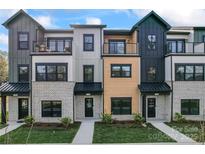 Modern townhome exteriors boast unique architectural details and inviting street appeal at 710 Falling Oak Aly # 17, Huntersville, NC 28078