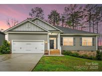 Charming single-Gathering home with an attached garage and a well-maintained lawn at 7186 Barleywood Dr, Locust, NC 28097