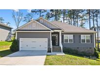 Charming one-story home with a gray exterior, white trim, an attached garage, and a well-manicured lawn at 7186 Barleywood Dr, Locust, NC 28097