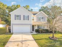 Charming two-story home with a well-maintained lawn, two-car garage, and beautiful landscaping at 1219 Century Dr, Clover, SC 29710
