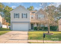 Charming two-story home with a well-manicured lawn and attached garage at 1219 Century Dr, Clover, SC 29710