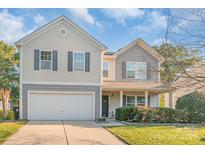 Inviting two-story home featuring a well-kept lawn and an attached two-car garage at 1219 Century Dr, Clover, SC 29710