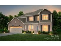 Charming two-story home with a brick and siding exterior, lush lawn, and an attached two-car garage at 124 Fordham Ct # 19, Fort Mill, SC 29715