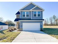 Two-story home with blue siding, white trim, a two-car garage and concrete driveway at 1525 Solitude Ct, Kannapolis, NC 28081