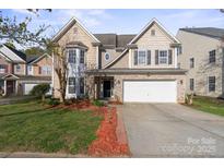 Charming two-story home featuring brick and siding exterior, a two-car garage, and a well-manicured front yard at 15814 Herring Gull Way, Charlotte, NC 28278