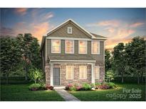 Charming two-story home with stone accents, a well-manicured lawn, and professionally landscaped flower beds at 15910 Parkside Crossing Dr # 318, Charlotte, NC 28278