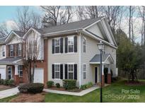 Charming two-story home with black shutters, manicured lawn, and inviting entryway at 16631 Commons Creek Dr, Charlotte, NC 28277