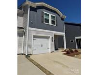 Charming home featuring gray and white siding, a single-car garage, and a welcoming entryway at 1843 Old Rivers Rd # 209, Concord, NC 28027