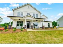 Charming two-story white home with a welcoming front porch and well-manicured lawn at 2009 Autumn Dr # 2, Monroe, NC 28110