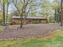 Charming brick ranch with double front doors and a beautifully landscaped front yard at 2600 Gemway Dr, Charlotte, NC 28216