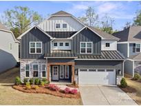 Beautiful two-story home featuring a two-car garage, stone accents, and professionally landscaped front yard at 4412 Foxview Ct, Charlotte, NC 28270