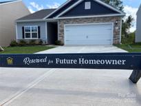 Charming single-Gathering home featuring a 2-car garage, stone accents, and a well-maintained lawn at 5711 Skinny Dr, Charlotte, NC 28215