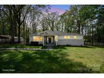 Well-lit home exterior at twilight features a covered porch and manicured lawn at 751 & 767 Pettit Rd, Catawba, SC 29704