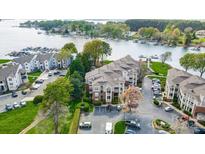 Breathtaking aerial view of lakeside condos with ample parking and meticulously maintained landscaping at 7836 Village Harbor Dr, Cornelius, NC 28031