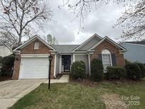 Charming single-story home featuring a brick and siding facade with an attached garage and well-maintained lawn at 10400 Brawley Ln # 8, Charlotte, NC 28215